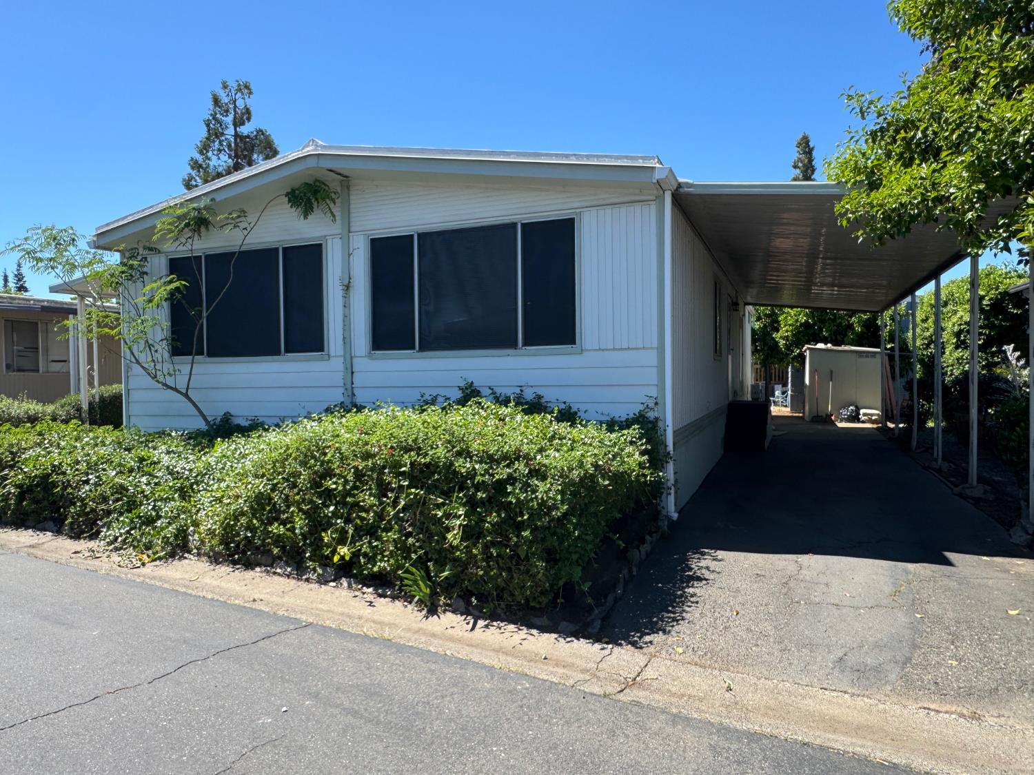 10035 Mills Station Road, Unit 161 Sacramento, CA 95827 - Photo 2 of 15 a front view of a house with a yard