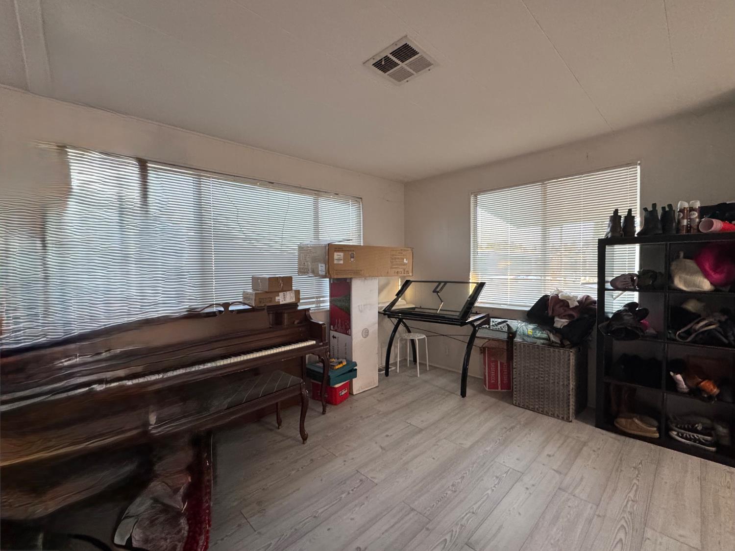 10035 Mills Station Road, Unit 161 Sacramento, CA 95827 - Photo 5 of 15 a room with wooden floor furniture and windows