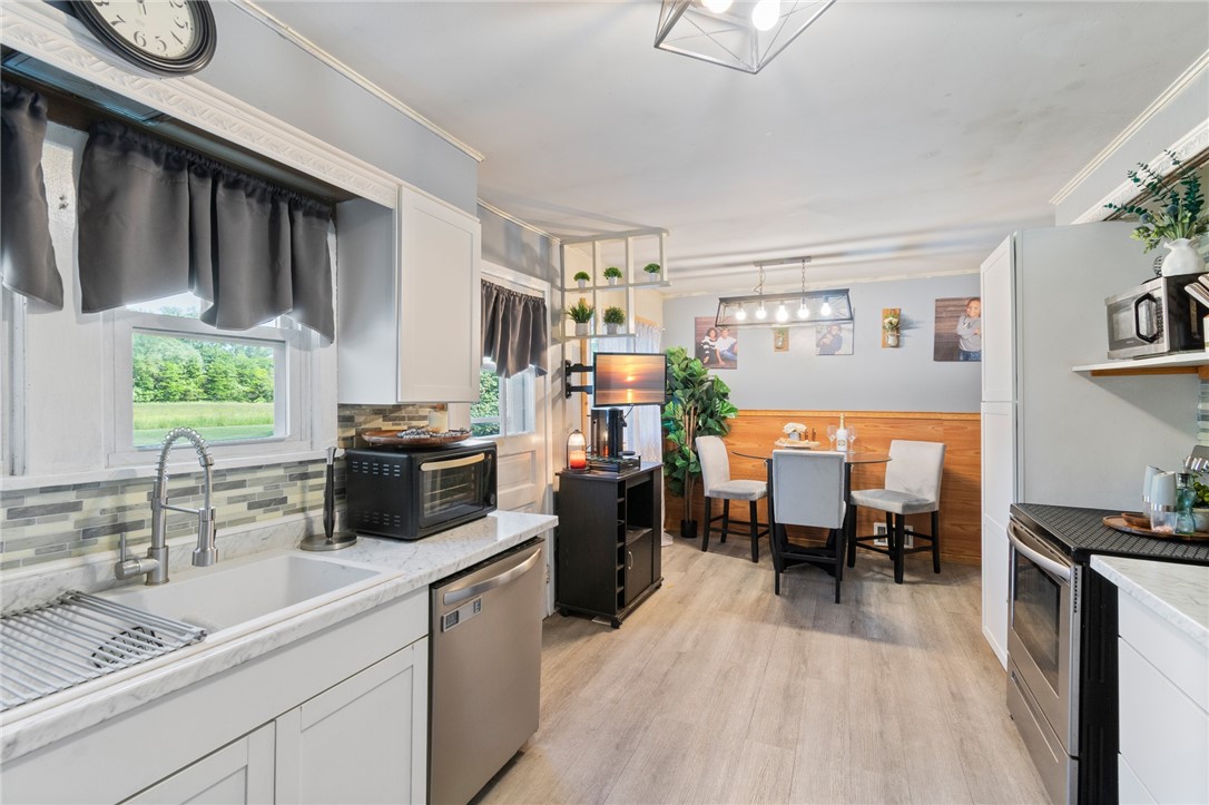 6170 Locust Street Williamson, NY 14589 - Photo 8 of 26 The kitchen to the dining area - newer counters an