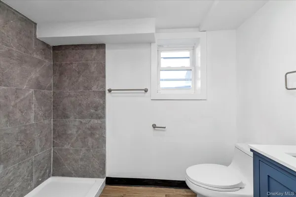 a white toilet sitting next to a bathroom sink and vanity