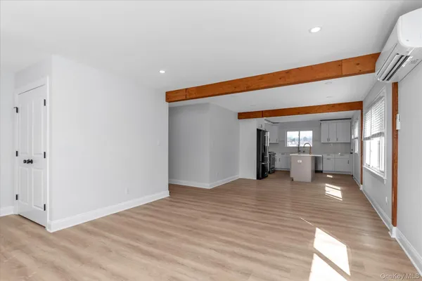 a view of a room with wooden floor