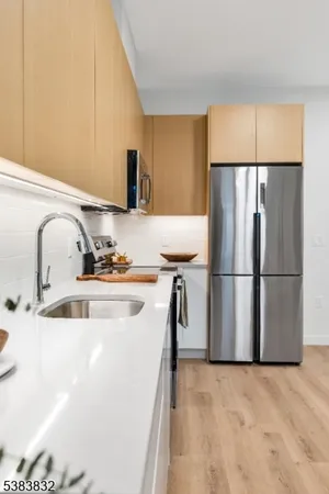 a kitchen with stainless steel appliances a refrigerator and a sink