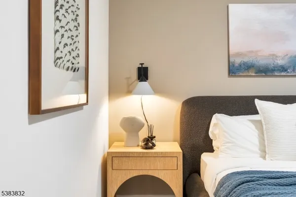 a bedroom with a bed and a painting on the wall