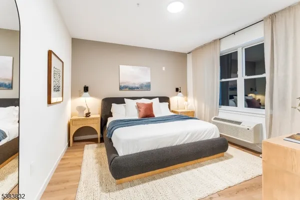 a bedroom with bed and a large window