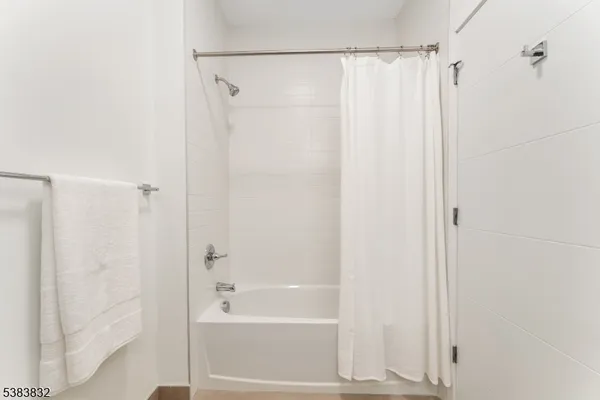 a bathroom with a shower and a bath tub