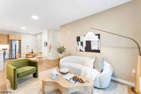 a living room with furniture and a chandelier