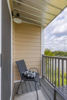 a roof deck with table and chairs