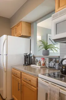a kitchen with stainless steel appliances white cabinets and a window