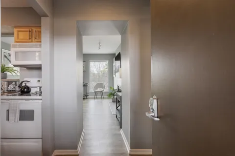 a bedroom with a bed and a potted plant with the dresser
