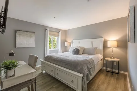 a spacious bedroom with a bed and window