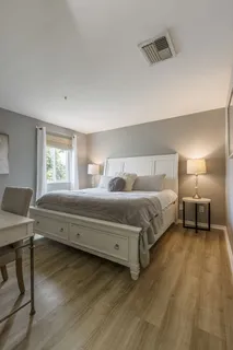 a bedroom with a bed and a lamp