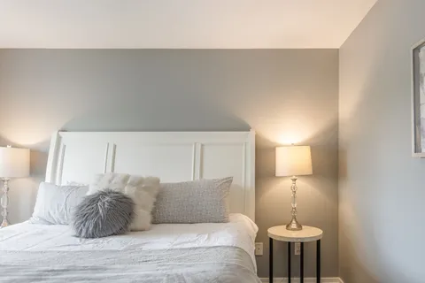 a bathroom with a granite countertop sink a toilet and mirror