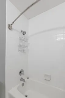 a view of a bedroom with wooden floor