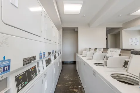 a view of a hallway with a couch and wooden floor