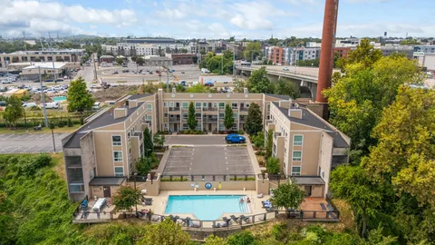 a aerial view of a residential apartment building with a yard and lake view