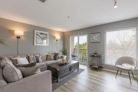 a living room with furniture and a large window