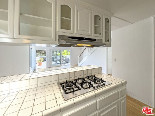a kitchen with granite countertop a stove and a sink