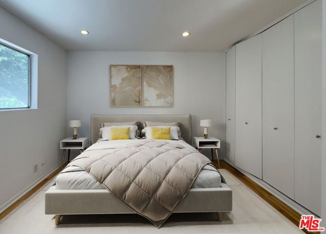 a bedroom with a bed and window