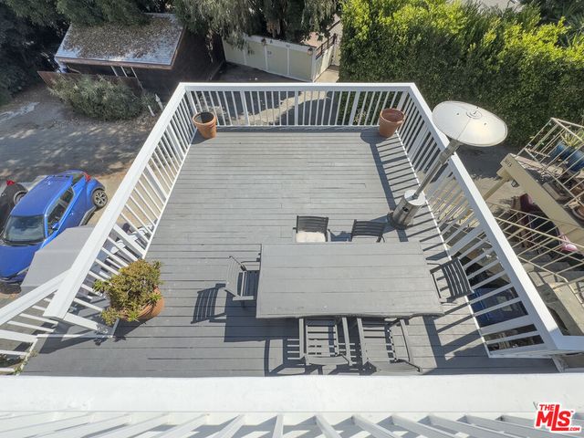a view of terrace with wooden floor and outdoor seating