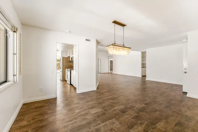 a view of a kitchen with a sink and a refrigerator