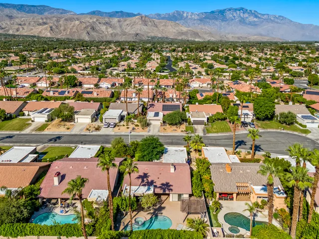 an aerial view of residential houses with outdoor space