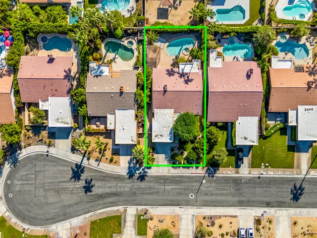 an aerial view of a house with a yard and sitting area