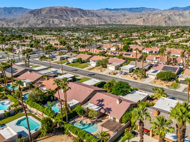 an aerial view of residential houses and outdoor space