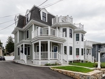 210 Adams Street, Unit 4 Waltham, MA 02453 - Photo 1 of 25 a front view of a building with a yard