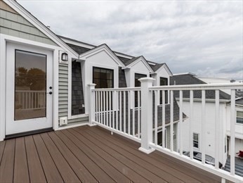 210 Adams Street, Unit 4 Waltham, MA 02453 - Photo 22 of 25 a view of a house with wooden deck