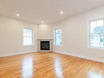 210 Adams Street, Unit 4 Waltham, MA 02453 - Photo 6 of 25 wooden floor in an empty room with a window