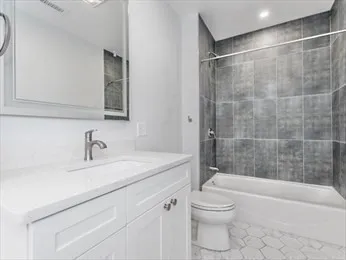 a bathroom with a sink a toilet and a bathtub