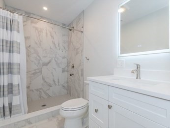 210 Adams Street, Unit 4 Waltham, MA 02453 - Photo 9 of 25 a bathroom with a sink a toilet and shower