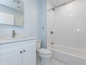 210 Adams Street, Unit 4 Waltham, MA 02453 - Photo 10 of 25 a bathroom with a sink toilet and shower