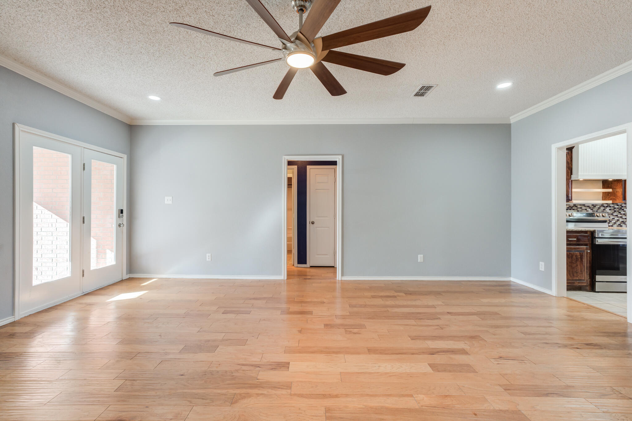 5917 88th Place Lubbock, TX 79424 - Photo 13 of 45 a view of an empty room with window and a kitchen