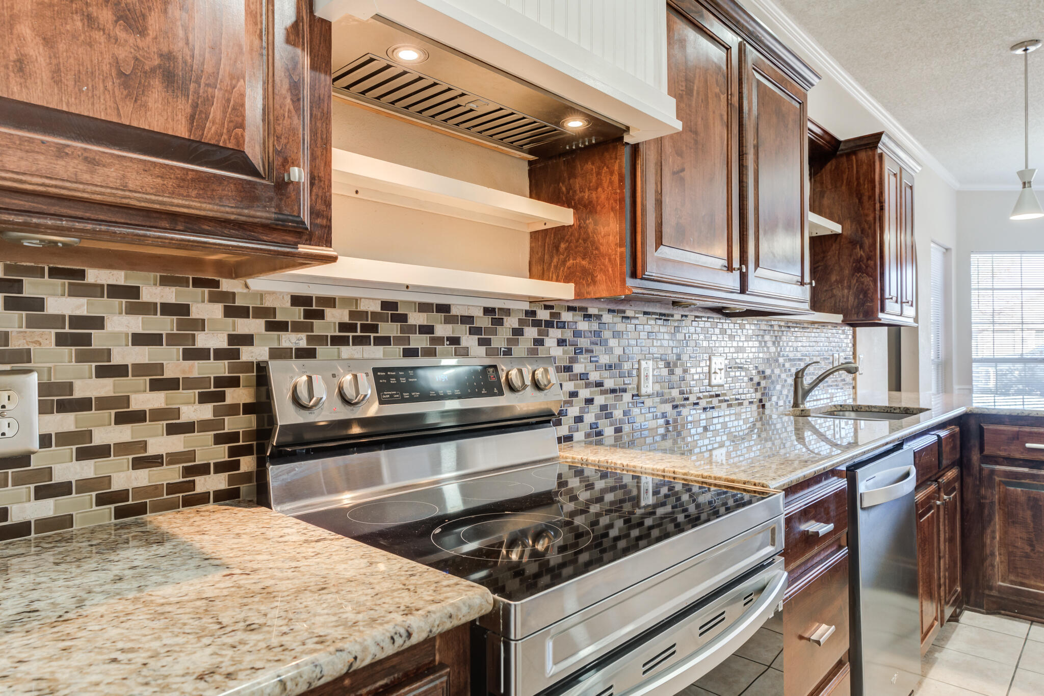 5917 88th Place Lubbock, TX 79424 - Photo 17 of 45 a kitchen with a stove and a sink