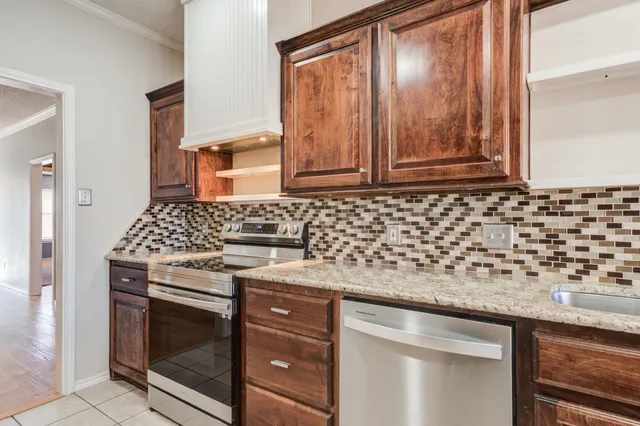 a kitchen with granite countertop cabinets and window