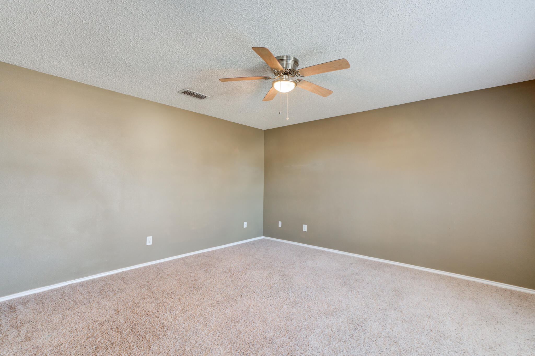 5917 88th Place Lubbock, TX 79424 - Photo 23 of 45 an empty room with a ceiling fan and wooden floor