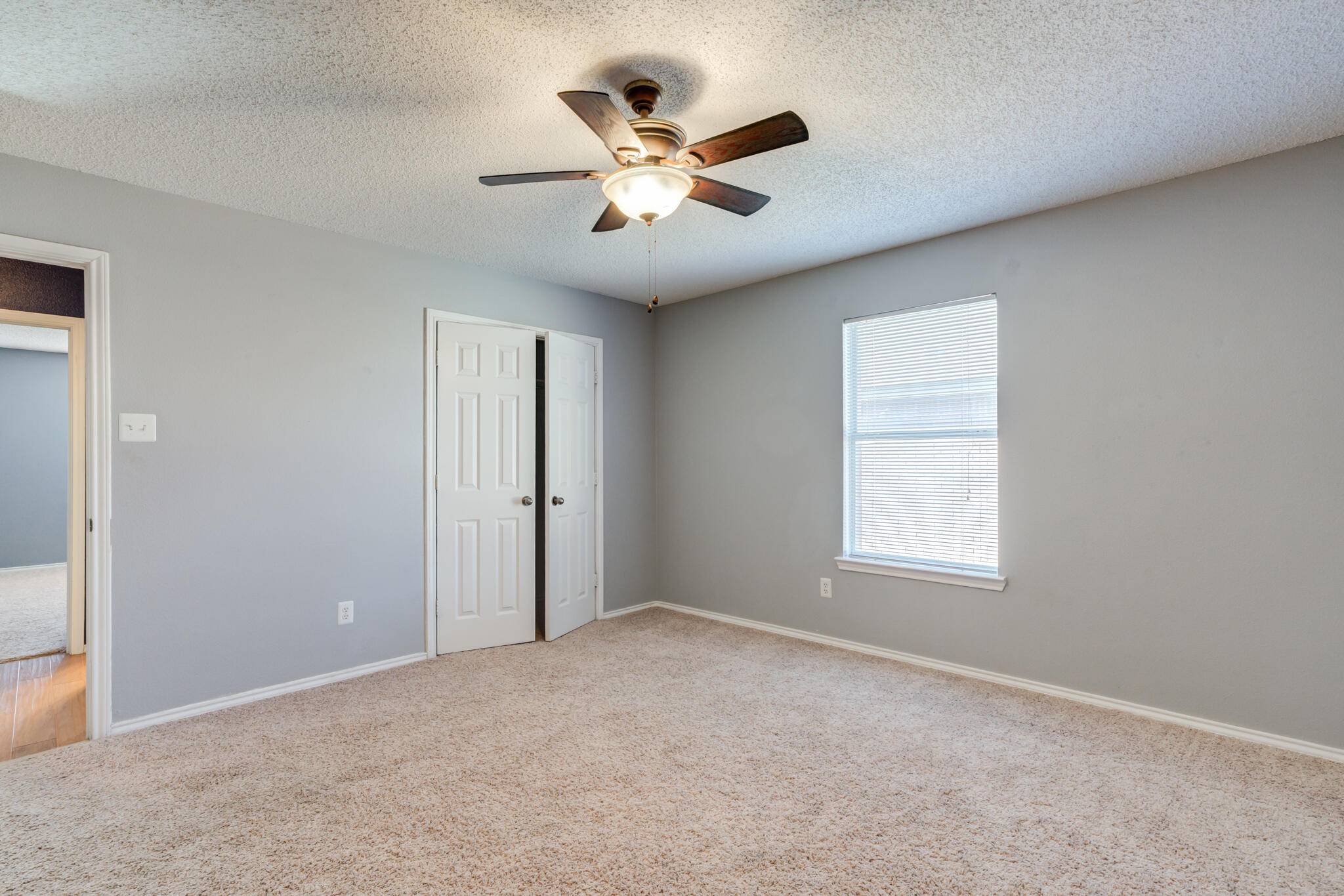 5917 88th Place Lubbock, TX 79424 - Photo 34 of 45 an empty room with window and ceiling fan