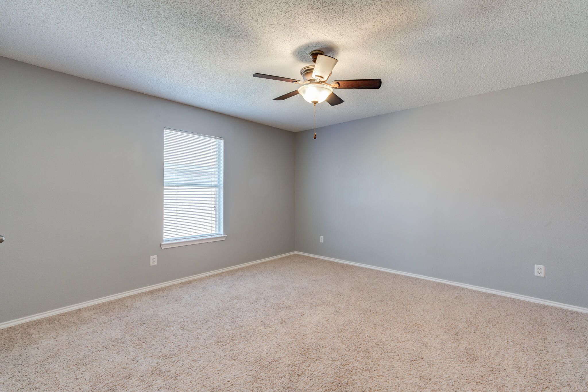 5917 88th Place Lubbock, TX 79424 - Photo 36 of 45 an empty room with windows and fan