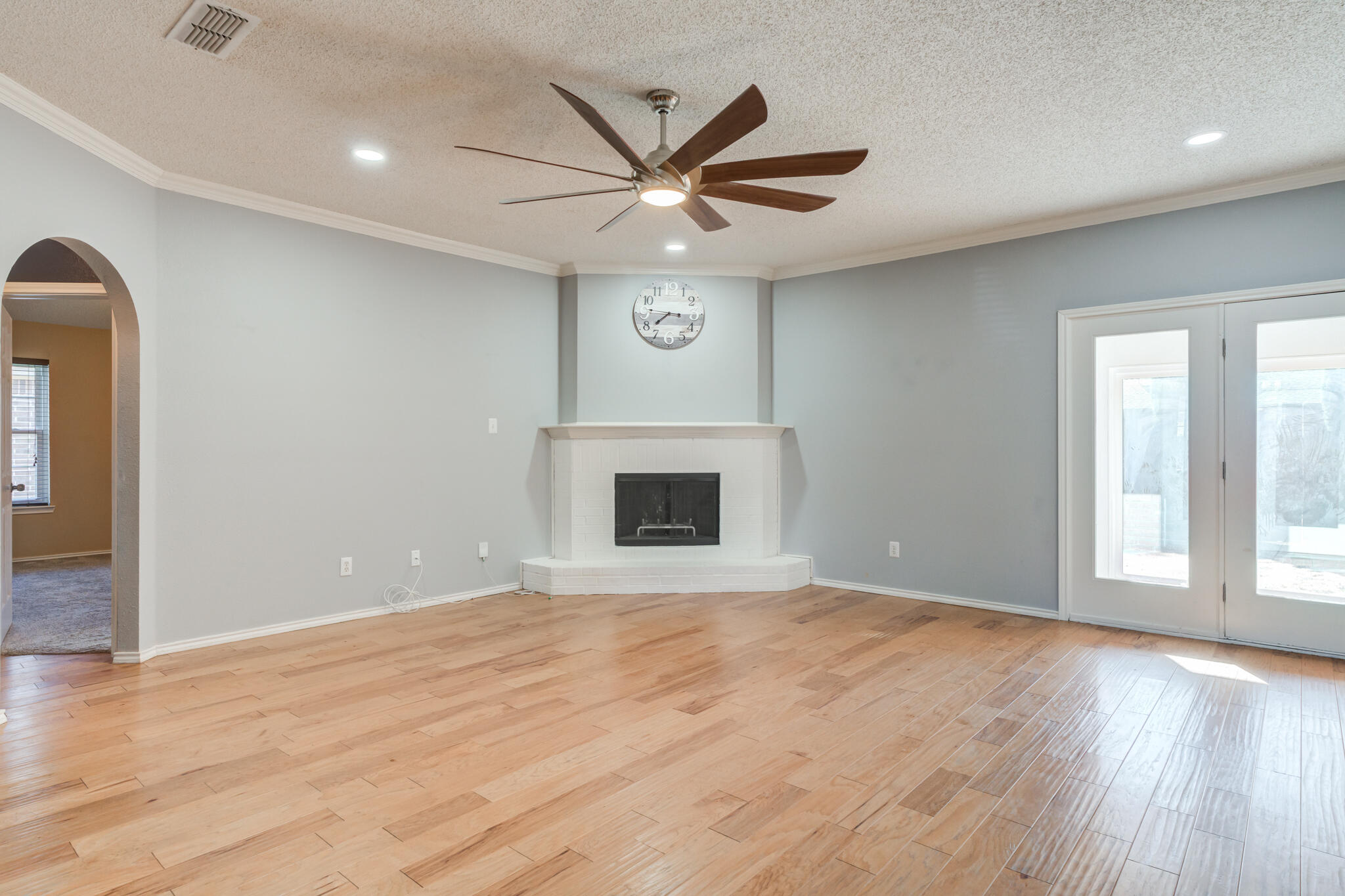 5917 88th Place Lubbock, TX 79424 - Photo 8 of 45 a view of an empty room with window and wooden floor