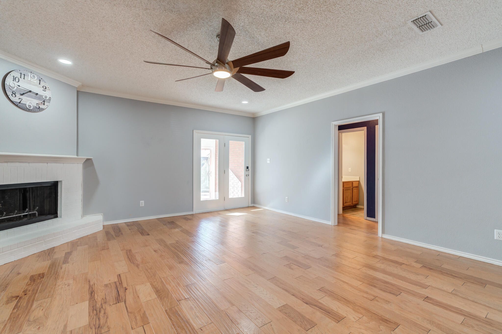 5917 88th Place Lubbock, TX 79424 - Photo 9 of 45 a view of empty room with wooden floor and fan