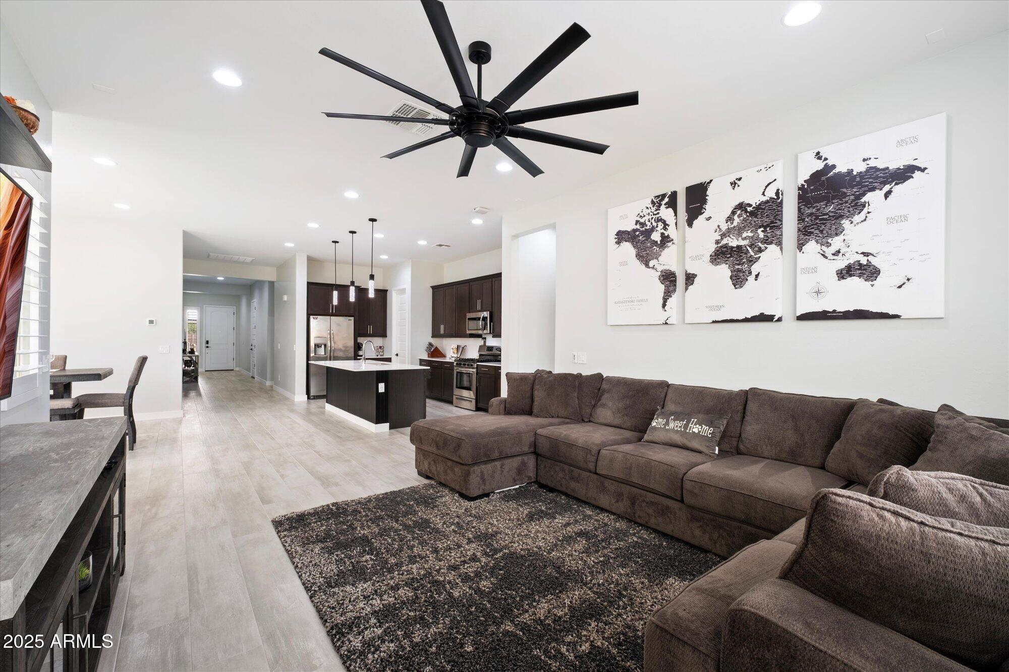20954 East Camacho Road Queen Creek, AZ 85142 - Photo 11 of 35 a living room with furniture kitchen view and a chandelier