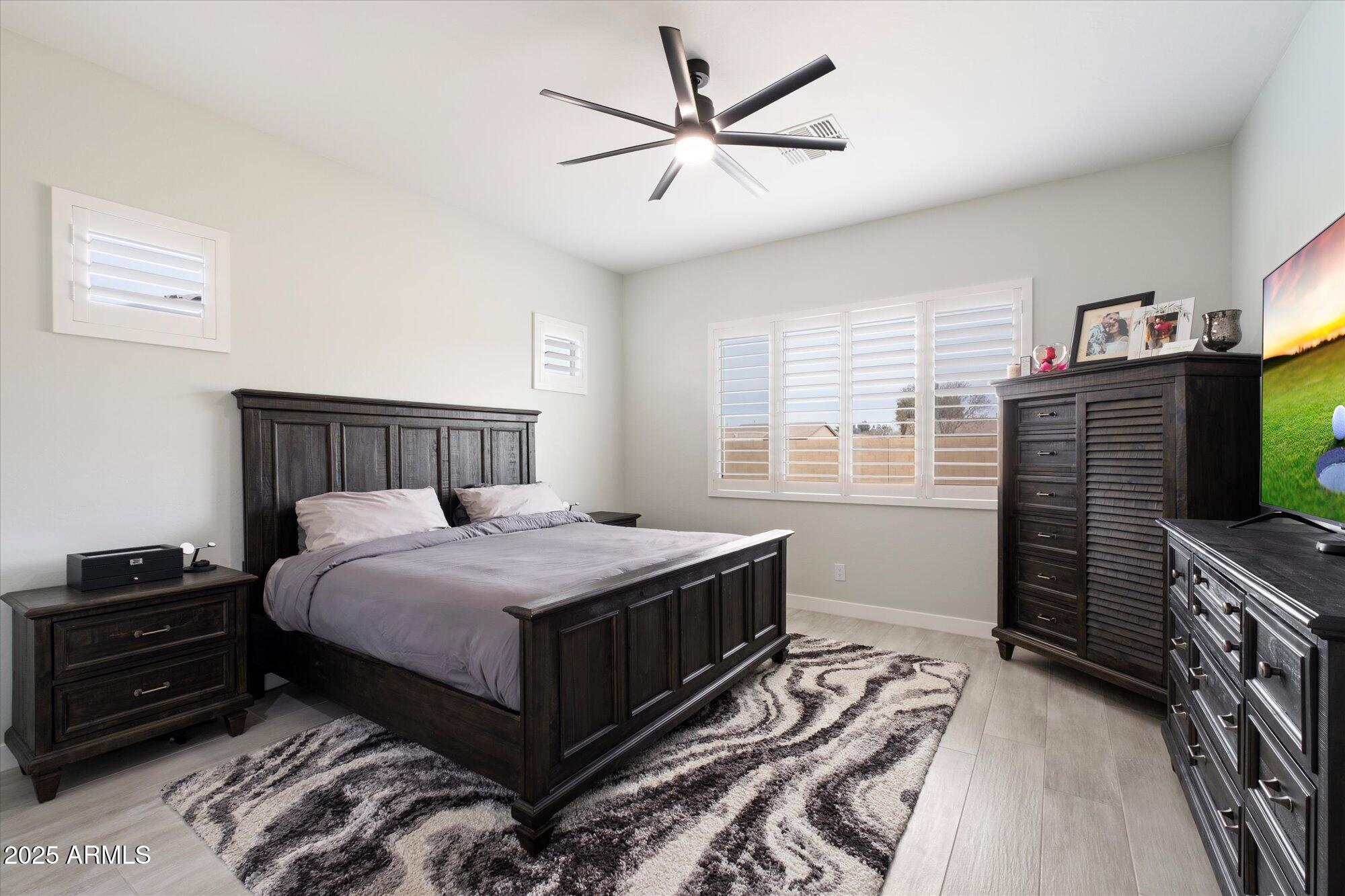 20954 East Camacho Road Queen Creek, AZ 85142 - Photo 12 of 35 a bedroom with a bed and a flat tv screen on a dresser