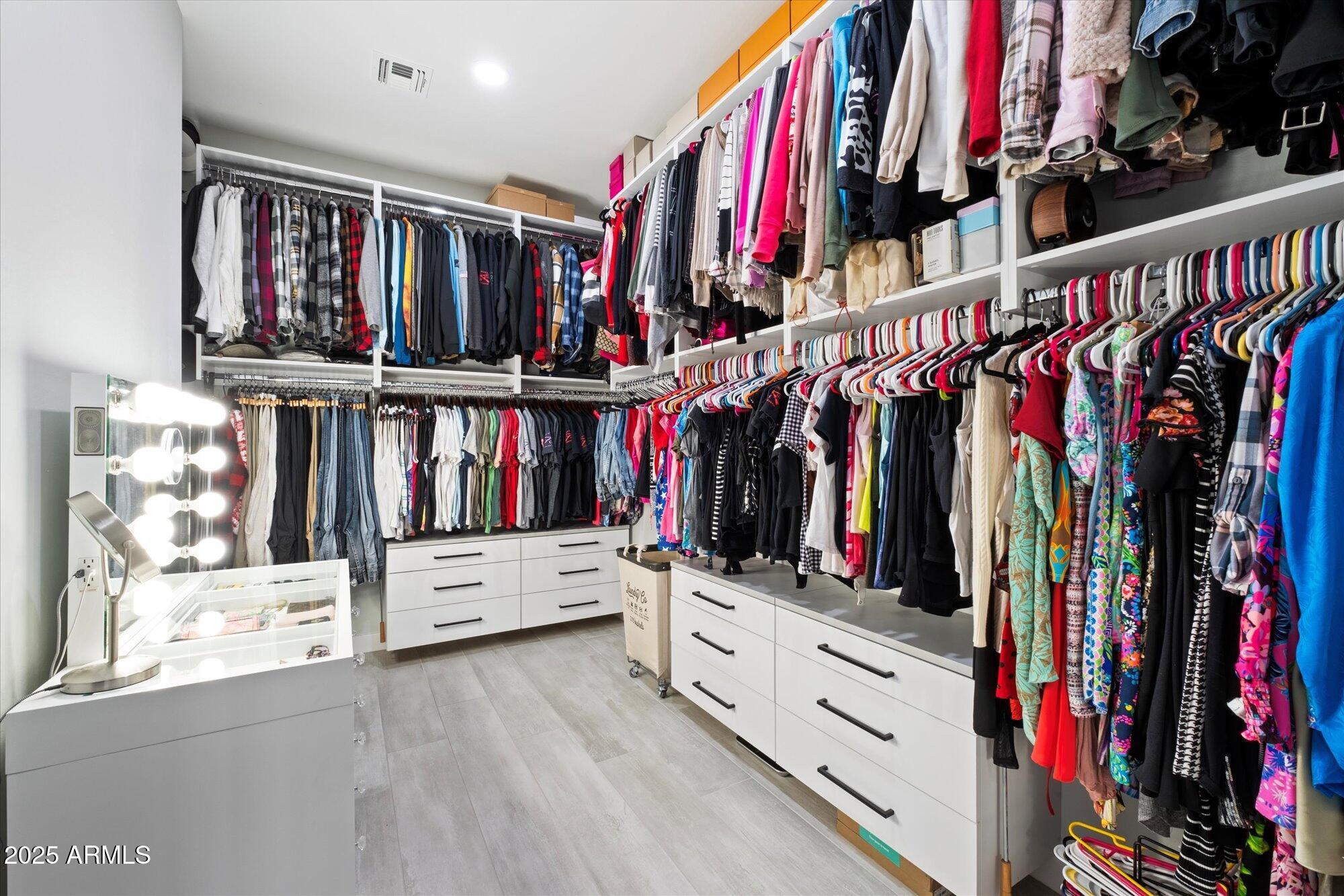 20954 East Camacho Road Queen Creek, AZ 85142 - Photo 16 of 35 a view of walk in closet with clothes and shoes