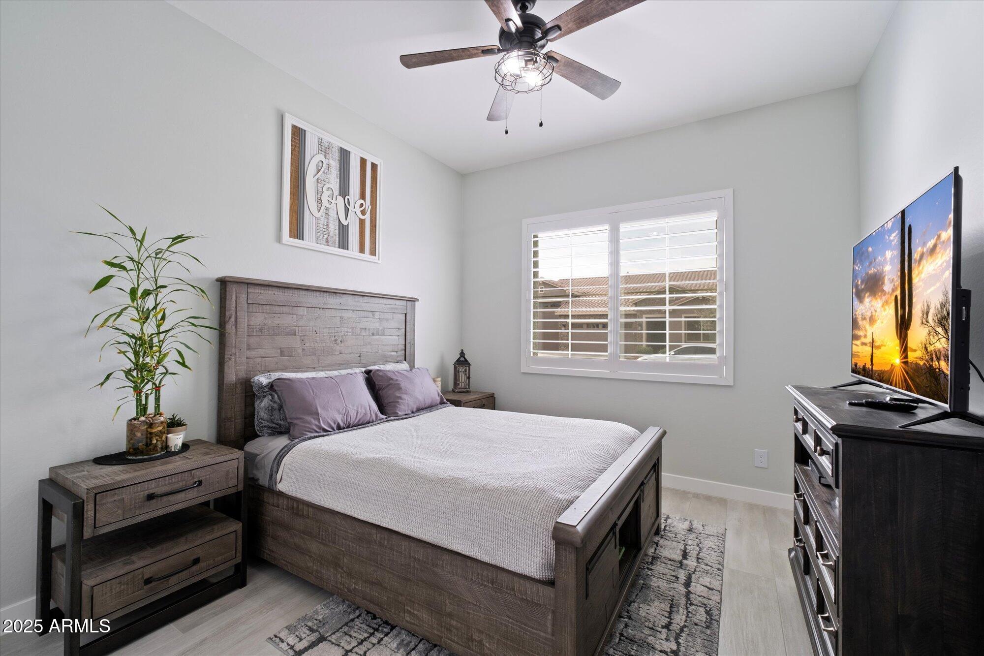 20954 East Camacho Road Queen Creek, AZ 85142 - Photo 17 of 35 a bedroom with a bed and a flat screen tv