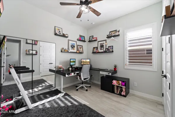 a view of a workspace with furniture and a window