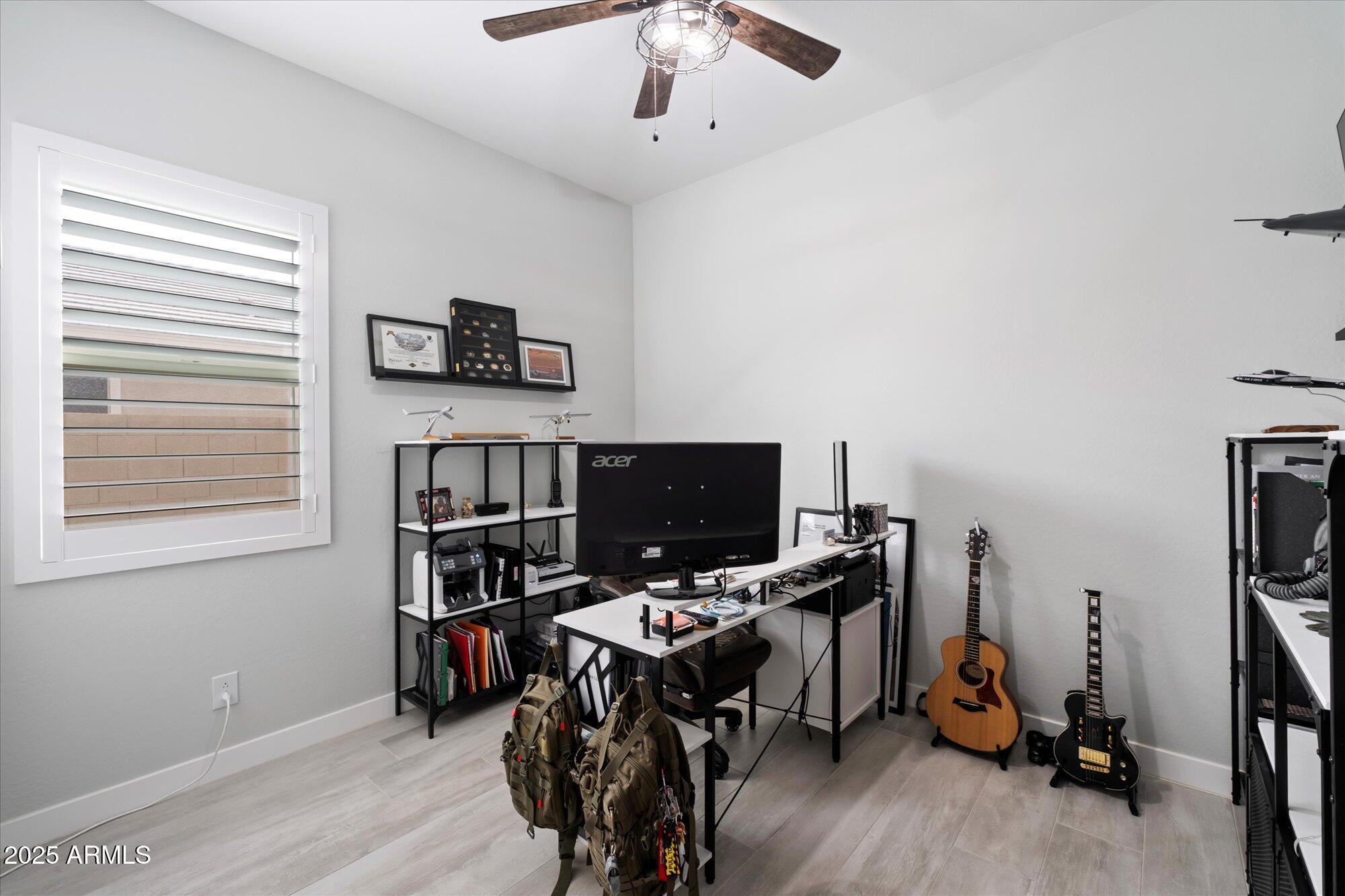 20954 East Camacho Road Queen Creek, AZ 85142 - Photo 20 of 35 a view of a workspace with furniture and a window