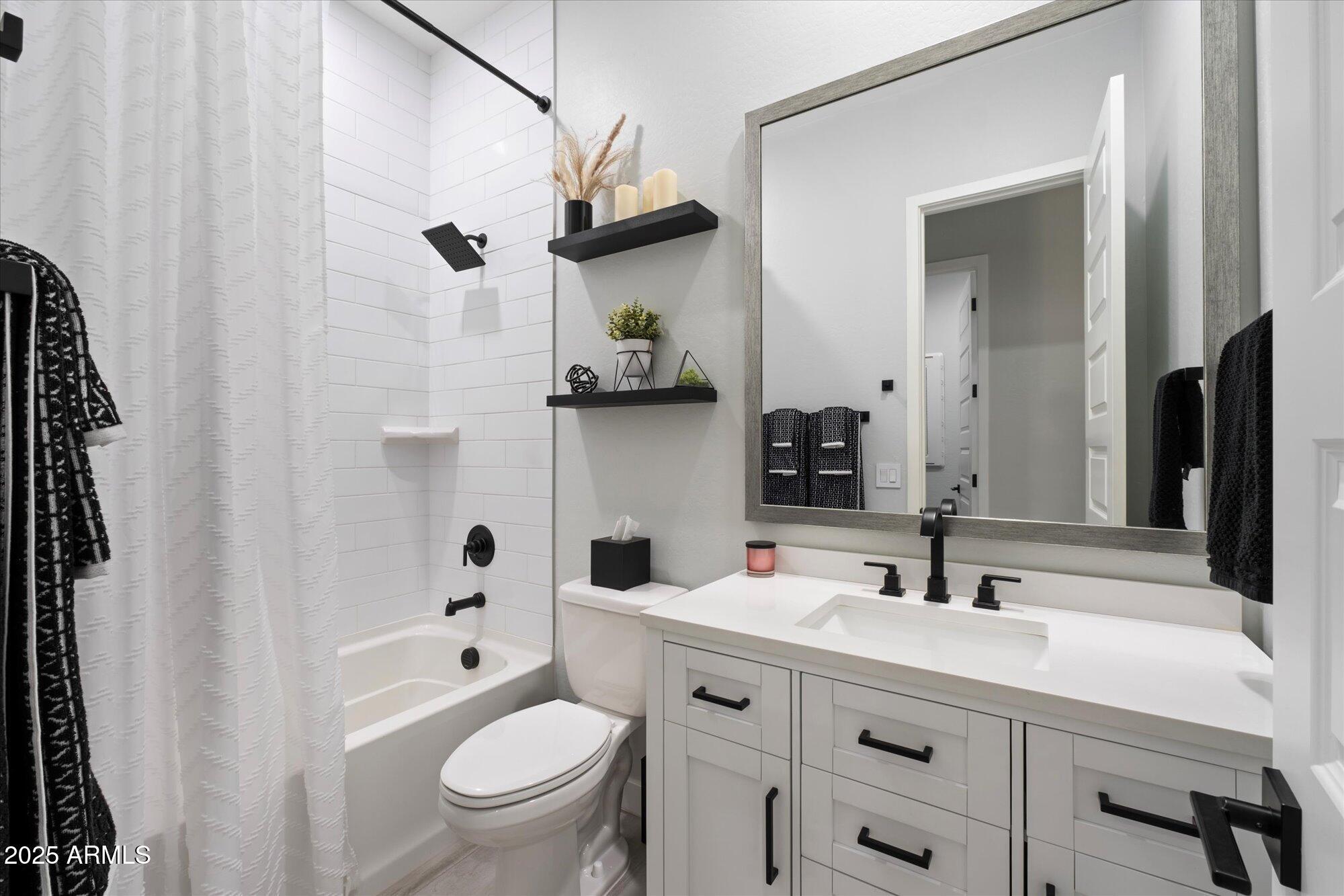 20954 East Camacho Road Queen Creek, AZ 85142 - Photo 21 of 35 a bathroom with a sink a toilet and a mirror