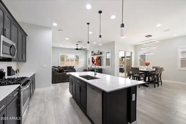 a kitchen with wooden cabinets and stainless steel appliances