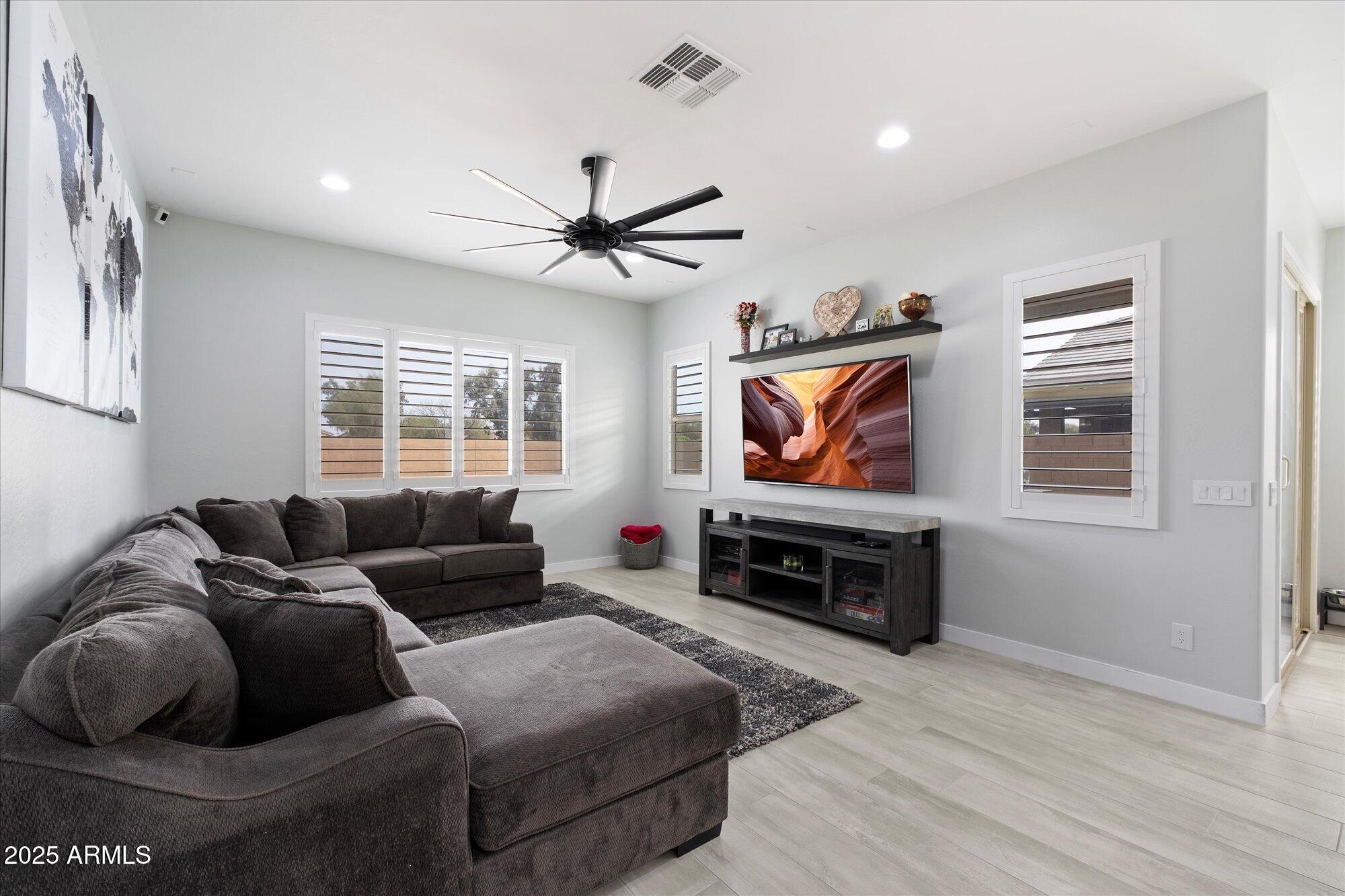 20954 East Camacho Road Queen Creek, AZ 85142 - Photo 10 of 35 a living room with furniture and a flat screen tv